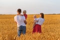 Rear view of father, mother and two children in wheat field. Young family with children outdoors Royalty Free Stock Photo