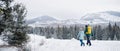 Rear view of father with small daughter on a walk outdoors in winter nature, Tatra mountains Slovakia. Royalty Free Stock Photo