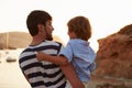 Rear View Of Father And Son Watching Sunset Over Harbour Royalty Free Stock Photo