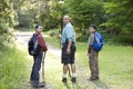 Rear view father and sons hiking in woods on trail Royalty Free Stock Photo