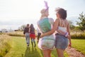 Rear View Of Female Friends Walking Back To Tent After Outdoor Music Festival Royalty Free Stock Photo