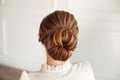 Rear view of female hairstyle medium bun with dark hair