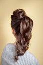 Rear view of female hairstyle volume braid.