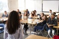 Rear View Of Female High School Teacher Standing At Front Of Class Teaching Lesson Royalty Free Stock Photo