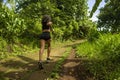 Rear view female runner training on countryside road - young attractive and fit jogger woman doing running workout outdoors at Royalty Free Stock Photo