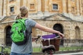 Rear View Of Female Student Riding Old Fashioned Bicycle Around Oxford University College Buildings By Radcliffe Camera In Royalty Free Stock Photo