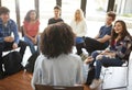 Rear View Of Female Tutor Leading Discussion Group Amongst High School Pupils