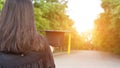 Rear view of a female university graduate stands and holds degree certificate to celebrate in the  graduation ceremony with clear Royalty Free Stock Photo