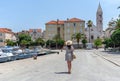 Rear view of a female walking on a street in the town of Supetar on Bra island in Croatia