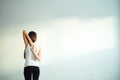 Rear view of fit woman doing gomukhasana in yoga class Royalty Free Stock Photo