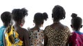 Rear view of five African females with different hairstyles, wearing colorful traditional clothing, backlit with a bright Royalty Free Stock Photo