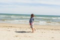 Rear view full shot girl walking to the shore of the beach in a