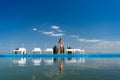 Rear view. girl in bathing suit stands between sun loungers by pool background sky Royalty Free Stock Photo