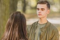 Rear view of a girl and boy looking at her with worried and unhappy facial exoression, while they are walking in city Royalty Free Stock Photo