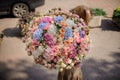 Rear view of girl with huge bouquet of flowers different colors