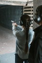 rear view of girl shooting with gun Royalty Free Stock Photo