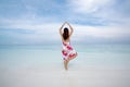 Rear view of gorgeous woman in yoga pose on the beach on a sunny Royalty Free Stock Photo