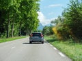 Rear view of gray Swedish Volvo V 60 car driving on French rural highway with