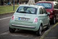 Rear view of green Fiat 500 Parked in the street