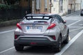 Rear view of grey Toyota C-hr hybrid parked in the street