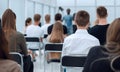 Rear view. a group of diverse young people sitting in a conference room. Royalty Free Stock Photo