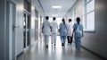Rear view of a group of doctors walking in a hospital corridor Royalty Free Stock Photo