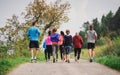 Rear view of group of multi generation people running a race competition in nature. Royalty Free Stock Photo