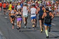 rear view group runners athletes women and men running city marathon