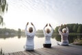 rear view of group of senior women doing yoga exercises on wooden pier in front of summer morning lake, neural network Royalty Free Stock Photo