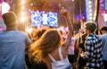 Rear view of group of young friends dancing at summer festival.