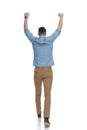 Rear view of happy casual man celebrating Royalty Free Stock Photo