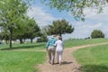 Rear view of happy senior couple walking in the Bluebonnet park