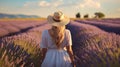 Rear view, Happy woman with hat walking through in lavender flowers field, Travel nature concept