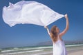 Happy woman holding scarf at beach Royalty Free Stock Photo