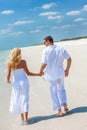 Happy Young Couple Running Holding Hands on A Tropical Beach Royalty Free Stock Photo