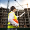 Rear view image of young engineer pointing at building with blue Royalty Free Stock Photo
