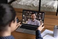 Rear view Indian woman making video call to colleague