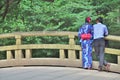 Rear view of Japanese couple standing on the bridge Royalty Free Stock Photo