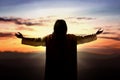 Rear view of Jesus Christ raised hands and praying to god Royalty Free Stock Photo