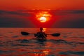 Rear view of kayaker man paddle kayak at sunset sea. Kayaking, canoeing, paddling. Royalty Free Stock Photo