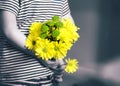 Rear view of kid with bunch of beautiful yellow Chrysanthemum behind his back preparing nice surprise for his mother or Father, Ch