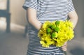 Rear view of kid with bunch of beautiful yellow Chrysanthemum behind his back preparing nice surprise for his mother or Father, Ch Royalty Free Stock Photo