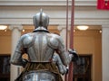 Rear view of a knight wearing 16th century German plate armor while holding a lance