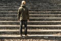 Rear view of a lonely man standing in front of endless stair Royalty Free Stock Photo
