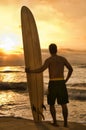 Rear view of Longboard Surfer Enjoying Sunset on Beach