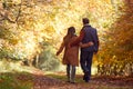 Rear View Of Loving Mature Couple Walking Along Track In Autumn Countryside Royalty Free Stock Photo