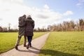 Rear View Of Loving Senior Couple Enjoying Autumn Or Winter Walk Through Park Together Royalty Free Stock Photo