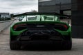 Rear view of a luxurious green Lamborghini Huracan Sto parked outdoors