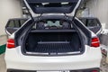 Rear view of luxury very expensive new white Mercedes-Benz GLE Coupe AMG 63s car stands with opened trunk in the washing box