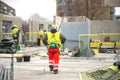 Rear view of male builder construction worker on building site wearing hard hat Royalty Free Stock Photo